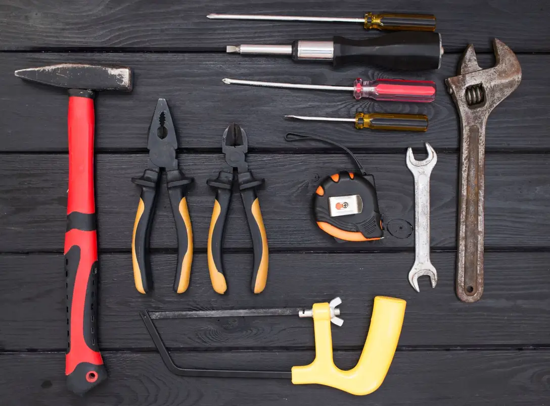 Contractor hand tools laid out on a workbench